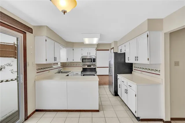 a kitchen with cabinets and a refrigerator