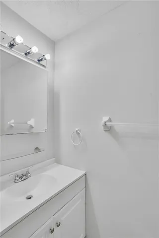 a bathroom with a sink vanity and mirror