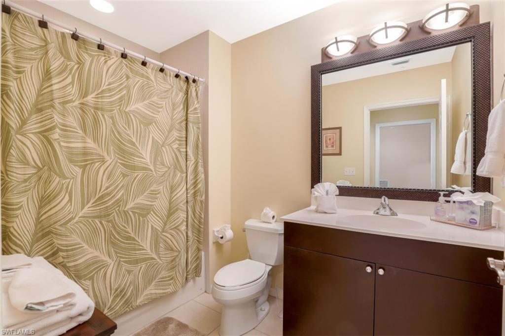 460 Launch Circle, Unit 403 Naples, FL 34108 - Photo 17 of 34 a bathroom with a sink and a mirror