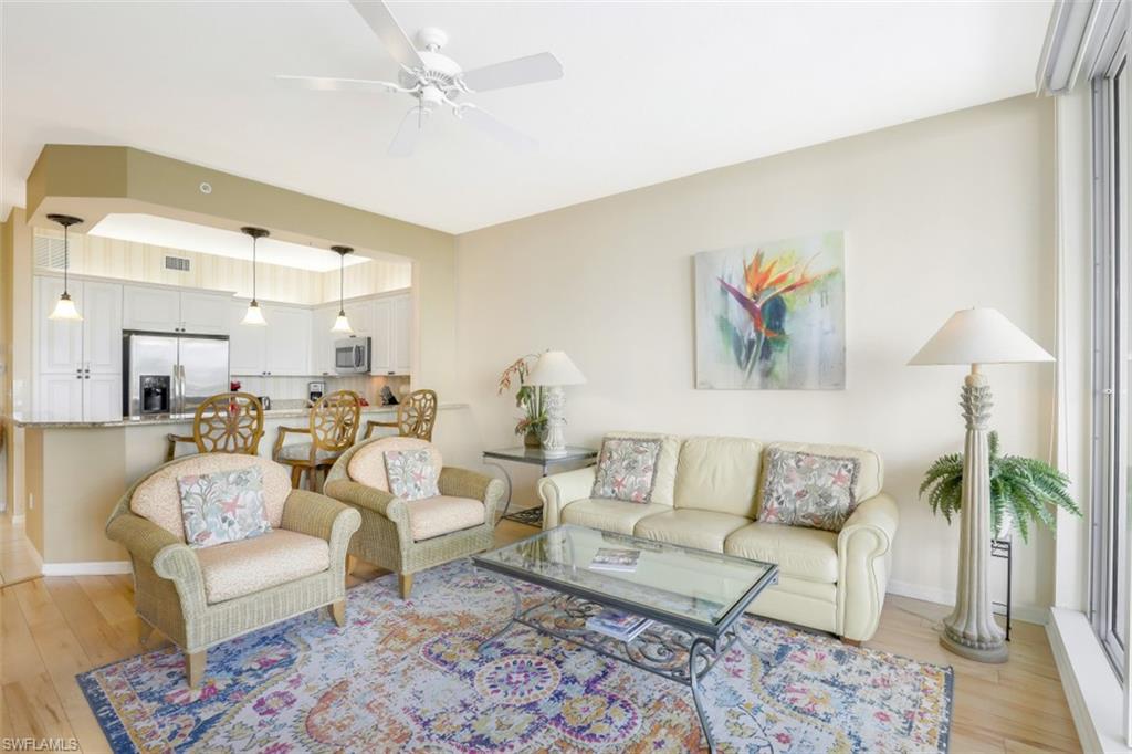 460 Launch Circle, Unit 403 Naples, FL 34108 - Photo 3 of 34 a living room with furniture and a potted plant