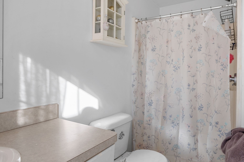 4 Mather Drive Wareham, MA 02571 - Photo 13 of 31 a bathroom with a toilet and a shower curtain