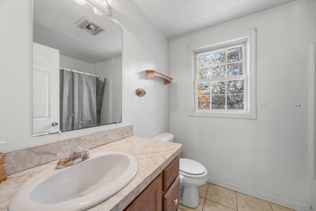 4 Mather Drive Wareham, MA 02571 - Photo 10 of 31 a bathroom with a toilet a sink a mirror a window and vanity