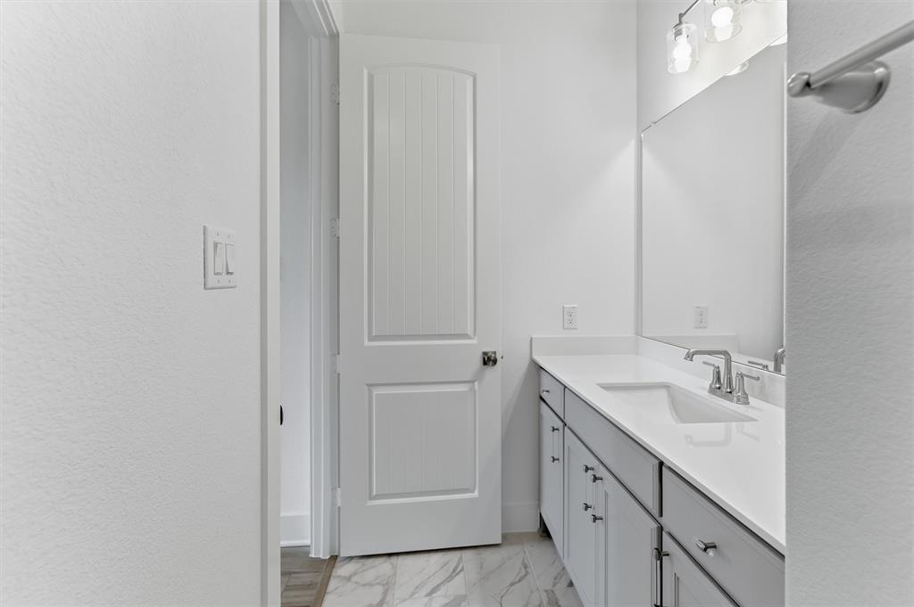 906 Perrin Lane Van Alstyne, TX 75495 - Photo 9 of 30 a spacious bathroom with a double vanity sink a mirror and a shower