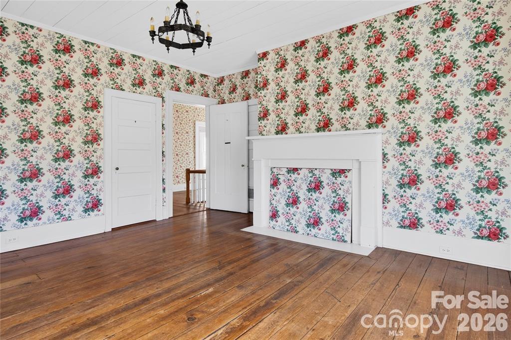 11124 Eastfield Road Huntersville, NC 28078 - Photo 29 of 41 a view of a hallway with paintings on the wall and wooden floor