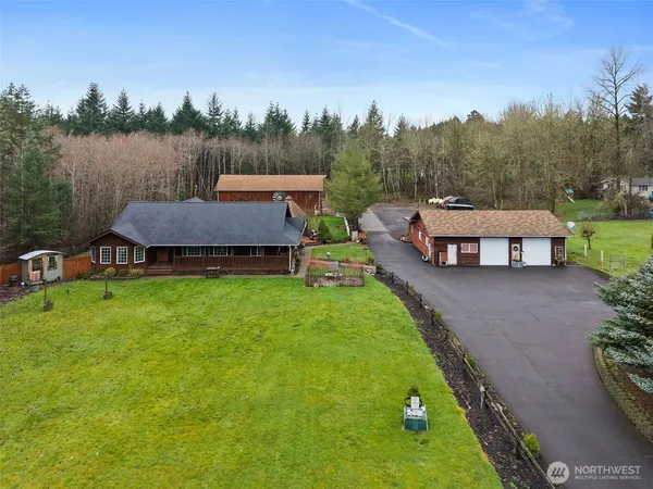 a view of a house with pool and a yard