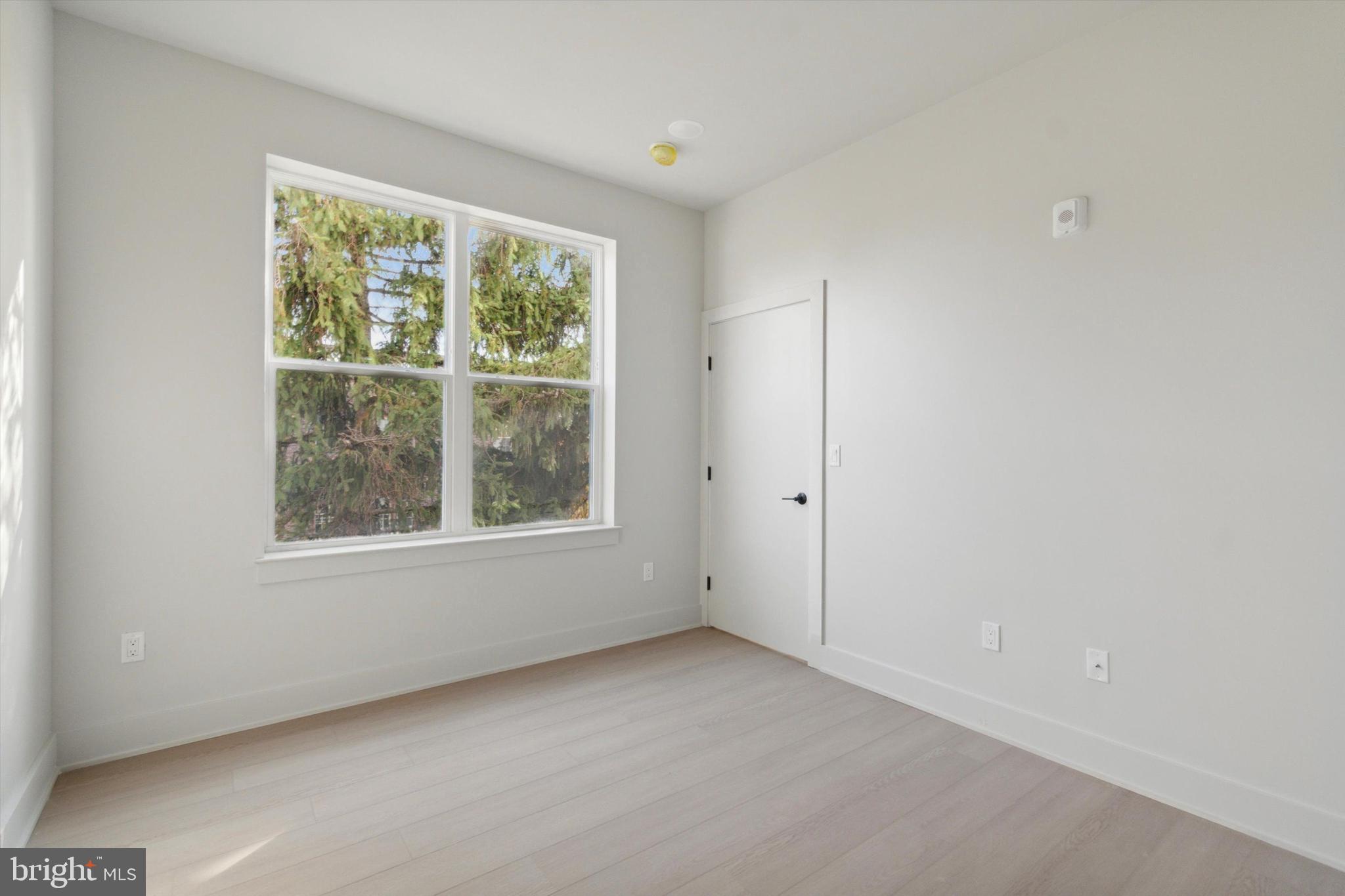 5521 Wayne Avenue, Unit 207 Philadelphia, PA 19144 - Photo 11 of 16 an empty room with windows