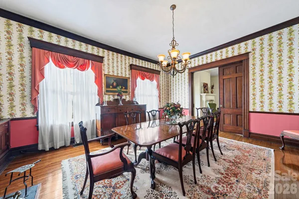 a view of a dining room with furniture and chandelier