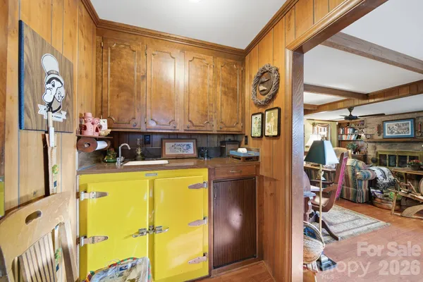 a kitchen with a table chairs stove and kitchen view