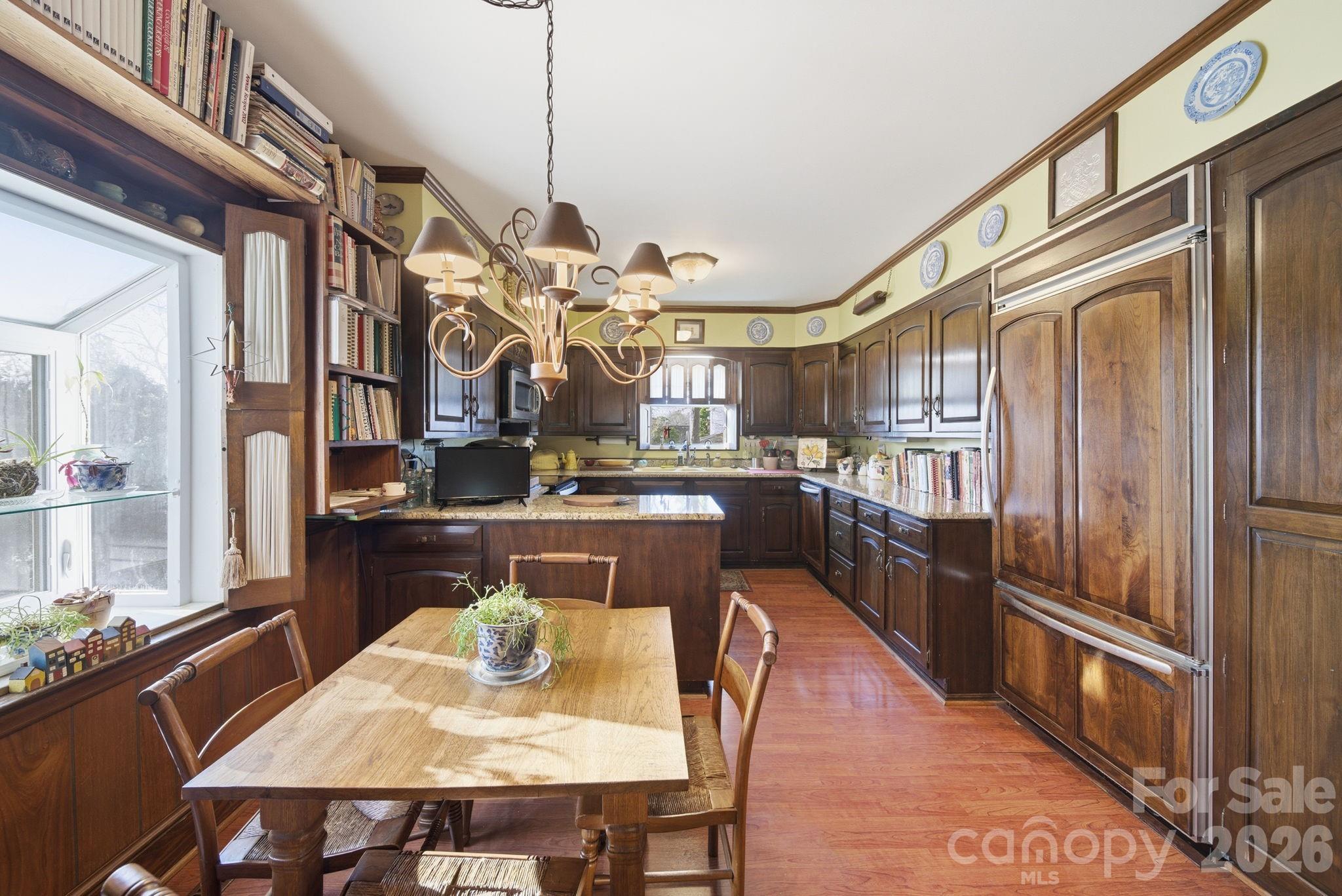 515 Camden Road Wadesboro, NC 28170 - Photo 15 of 36 a dining room with stainless steel appliances granite countertop a dining table chairs a refrigerator and kitchen view