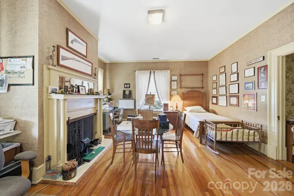 a bedroom with bed and a lounge chair