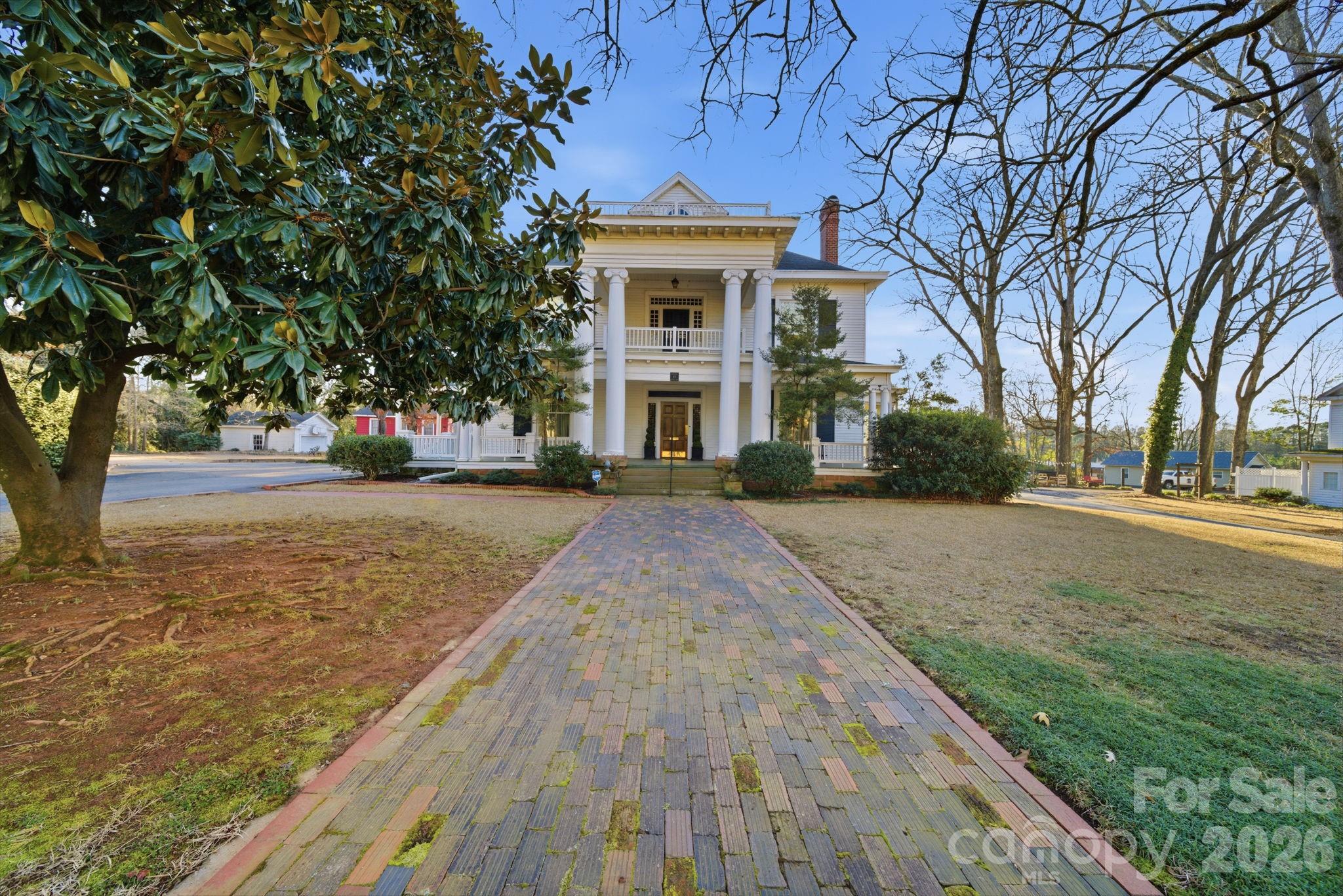 515 Camden Road Wadesboro, NC 28170 - Photo 3 of 36 a front view of a house with a yard and trees