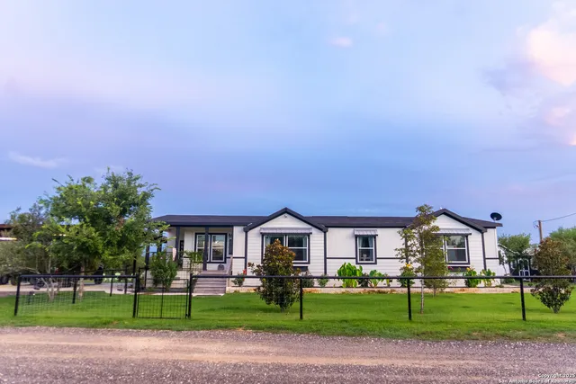 a front view of house with yard and green space