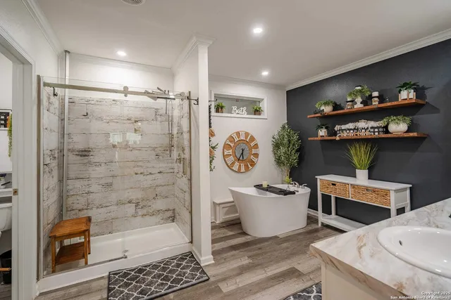 a spacious bathroom with a bathtub a sink and a shower