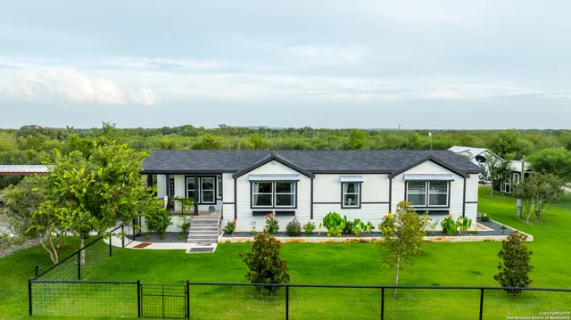 a front view of a house with a yard table and chairs