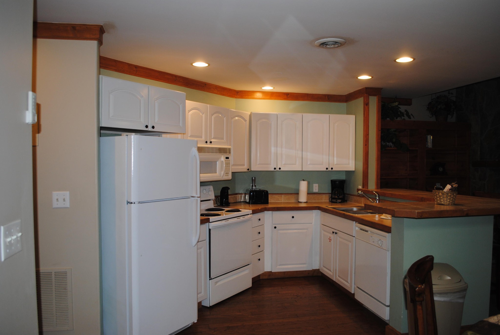 206 Forrest Loop Way, Unit 23 Gatlinburg, TN 37738 - Photo 4 of 16 a kitchen with a sink a refrigerator and cabinets