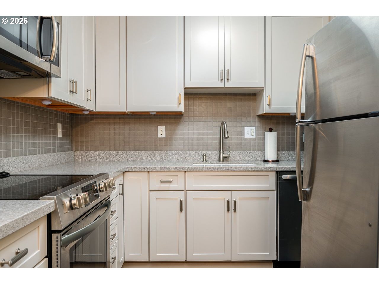 4460 Southwest Scholls Ferry Road, Unit 6A Portland, OR 97225 - Photo 11 of 25 a kitchen with stainless steel appliances granite countertop a stove a refrigerator and a sink
