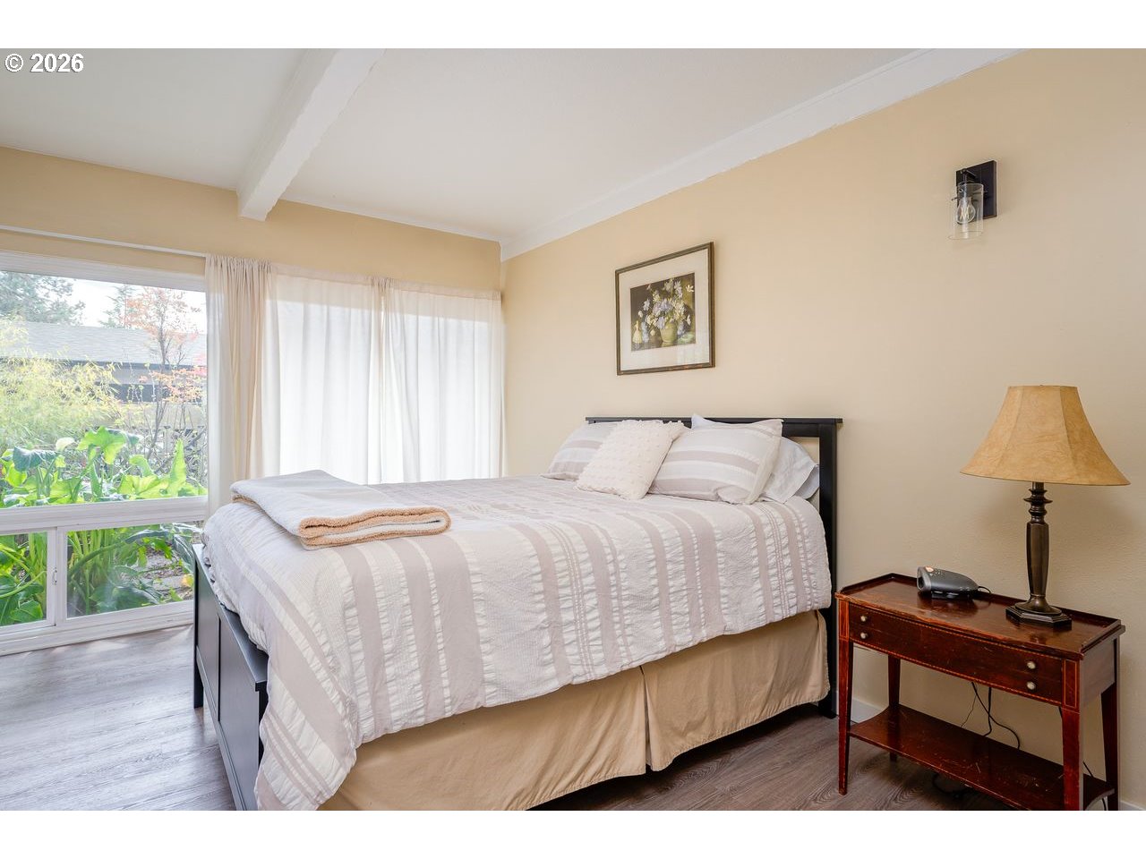 4460 Southwest Scholls Ferry Road, Unit 6A Portland, OR 97225 - Photo 14 of 25 a bedroom with a bed wooden floor and window