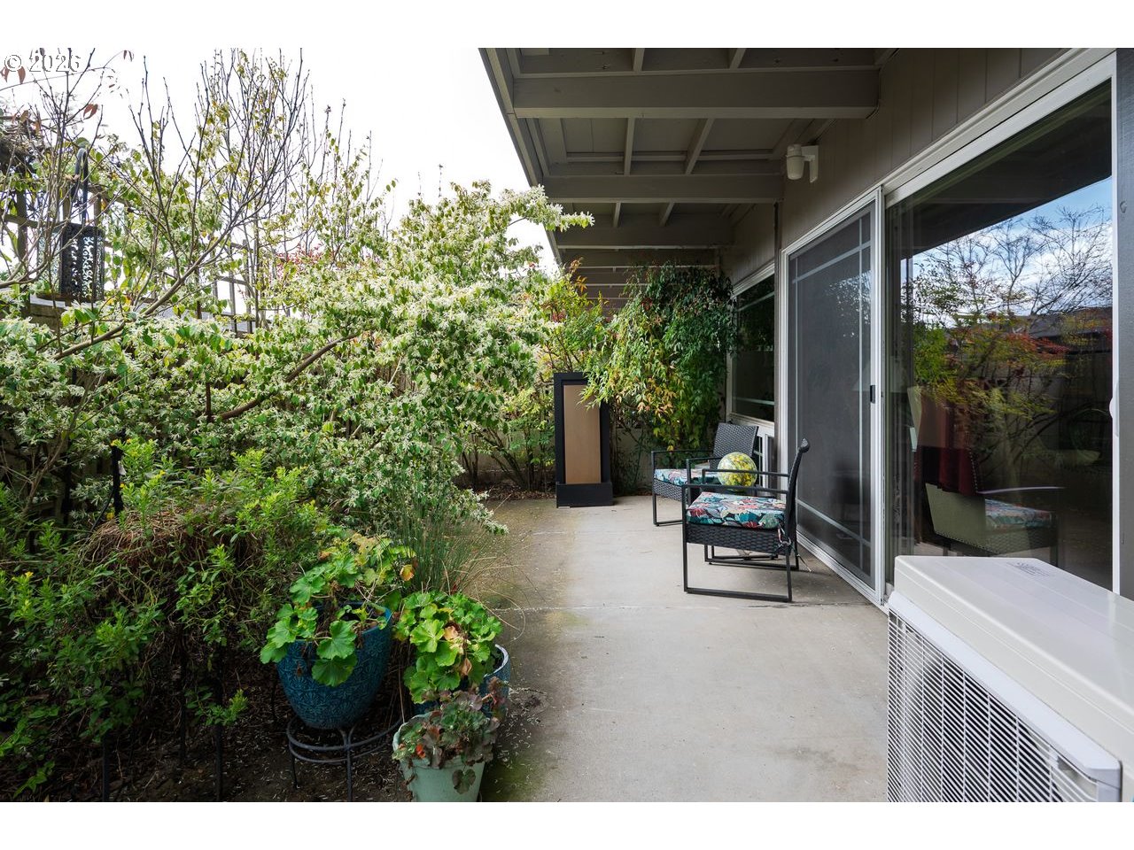 4460 Southwest Scholls Ferry Road, Unit 6A Portland, OR 97225 - Photo 19 of 25 a backyard of a house with outdoor seating and green space