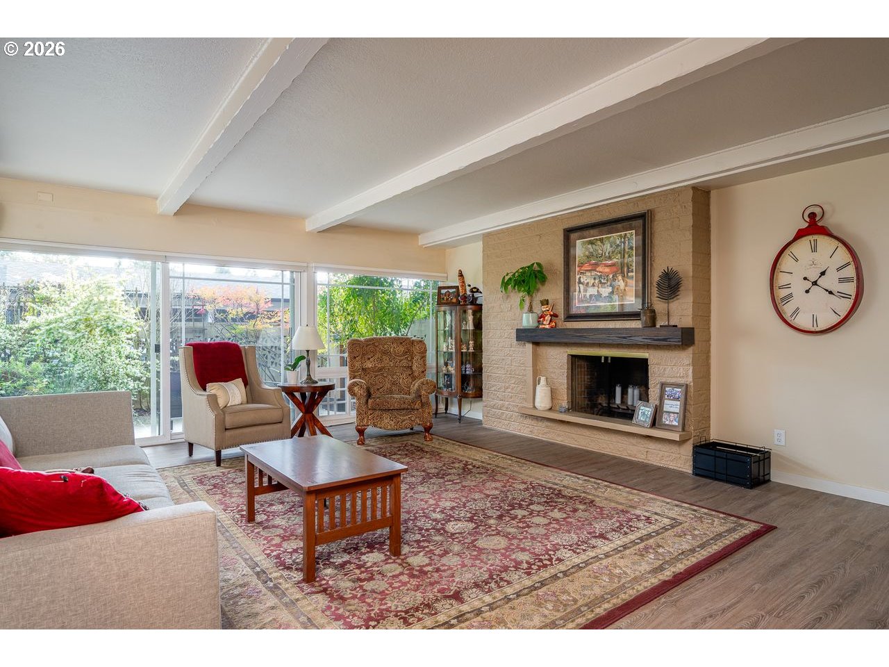 4460 Southwest Scholls Ferry Road, Unit 6A Portland, OR 97225 - Photo 3 of 25 a living room with furniture a clock and a fireplace