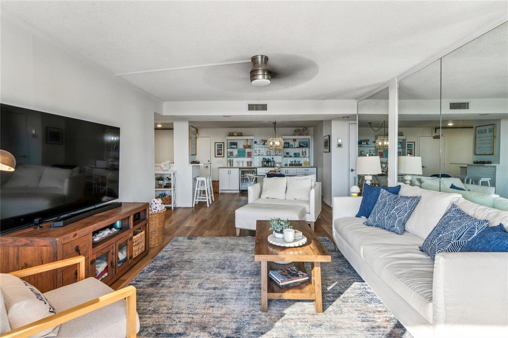 1 Key Capri, Unit 312E Treasure Island, FL 33706 - Photo 13 of 86 a living room with furniture and a flat screen tv