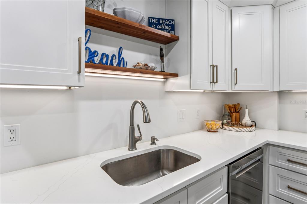 1 Key Capri, Unit 312E Treasure Island, FL 33706 - Photo 19 of 86 a kitchen with a sink and cabinets