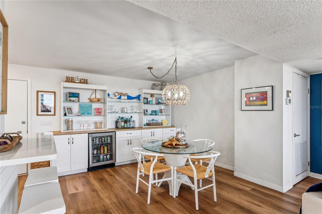 1 Key Capri, Unit 312E Treasure Island, FL 33706 - Photo 21 of 86 a view of a dining room with furniture and wooden floor