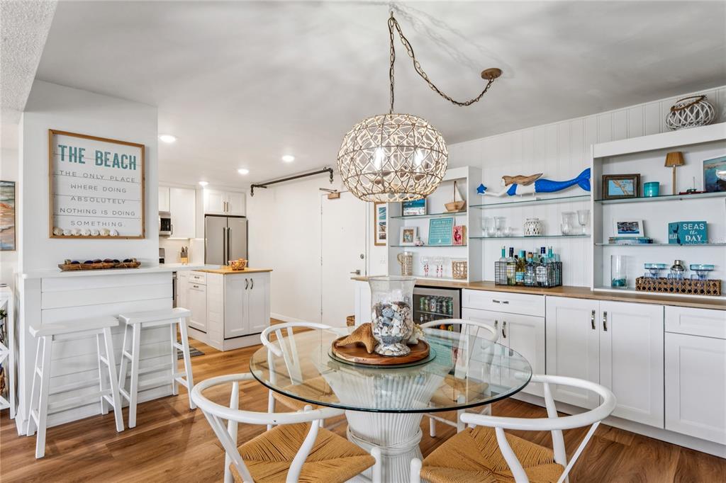1 Key Capri, Unit 312E Treasure Island, FL 33706 - Photo 22 of 86 a kitchen with stainless steel appliances granite countertop a dining table and chairs