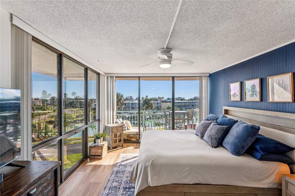 1 Key Capri, Unit 312E Treasure Island, FL 33706 - Photo 24 of 86 a bedroom with a large bed and a balcony view