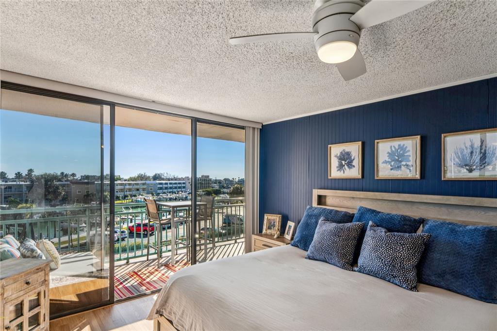 1 Key Capri, Unit 312E Treasure Island, FL 33706 - Photo 25 of 86 a bedroom with a large bed and a large window