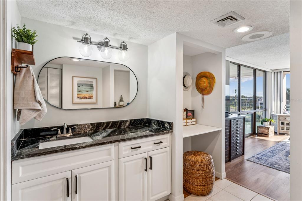 1 Key Capri, Unit 312E Treasure Island, FL 33706 - Photo 28 of 86 a bathroom with a sink and a mirror
