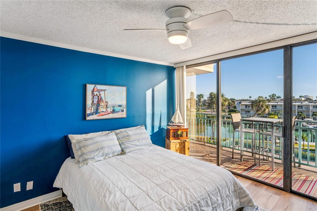 1 Key Capri, Unit 312E Treasure Island, FL 33706 - Photo 32 of 86 a bedroom with a large bed and a large window