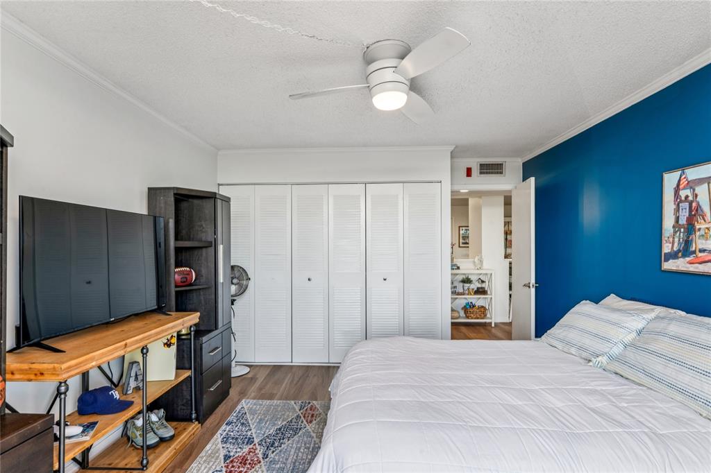 1 Key Capri, Unit 312E Treasure Island, FL 33706 - Photo 34 of 86 a bedroom with bed and wooden floor