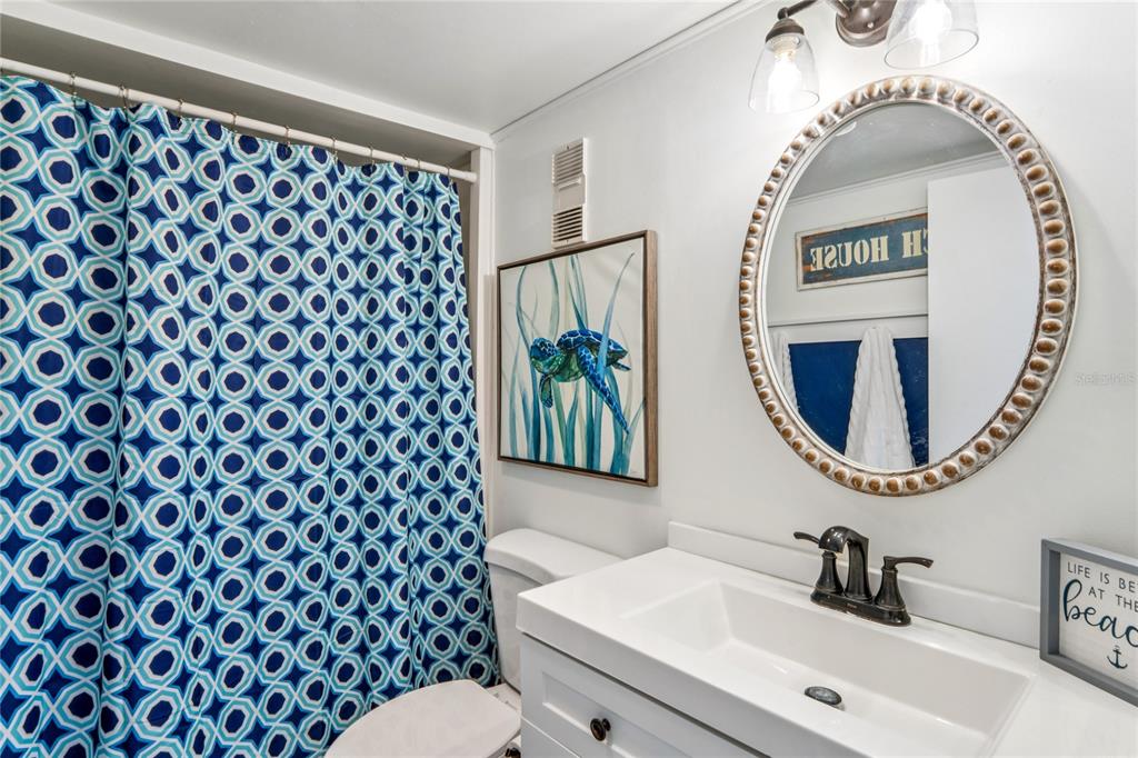 1 Key Capri, Unit 312E Treasure Island, FL 33706 - Photo 35 of 86 a bathroom with a sink and a mirror