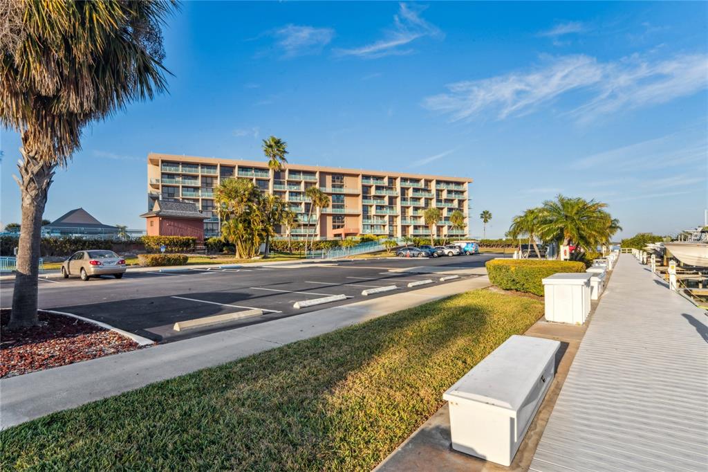 1 Key Capri, Unit 312E Treasure Island, FL 33706 - Photo 50 of 86 a view of swimming pool with outdoor seating and plants