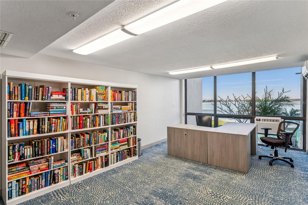 1 Key Capri, Unit 312E Treasure Island, FL 33706 - Photo 75 of 86 a living room with a book shelf and a book shelf