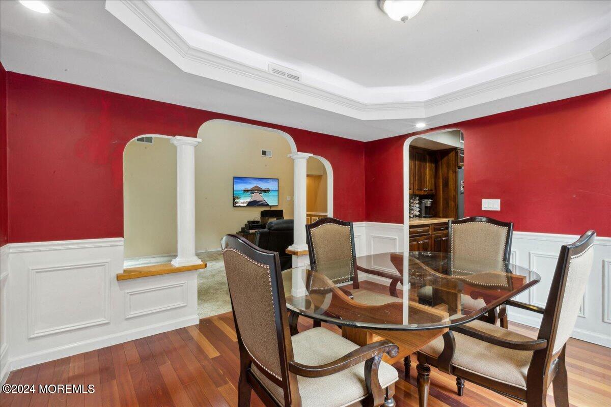 490 Iron Bridge Road Freehold, NJ 07728 - Photo 14 of 40 a view of a dining room with furniture and wooden floor