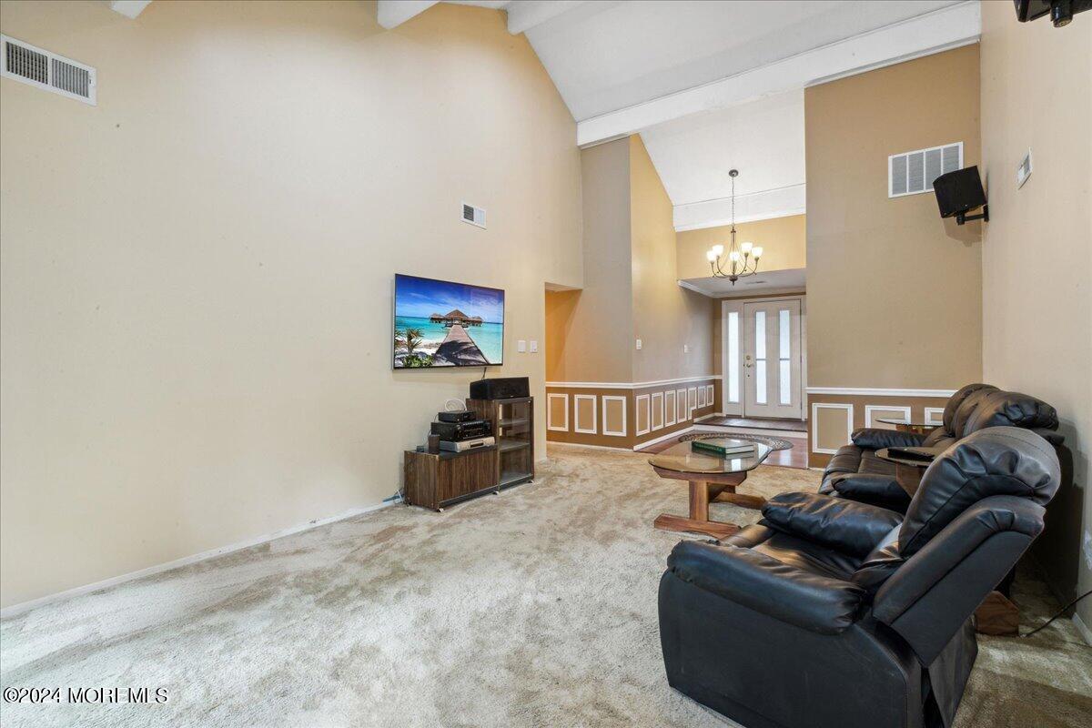 490 Iron Bridge Road Freehold, NJ 07728 - Photo 15 of 40 a living room with furniture a window and a flat screen tv