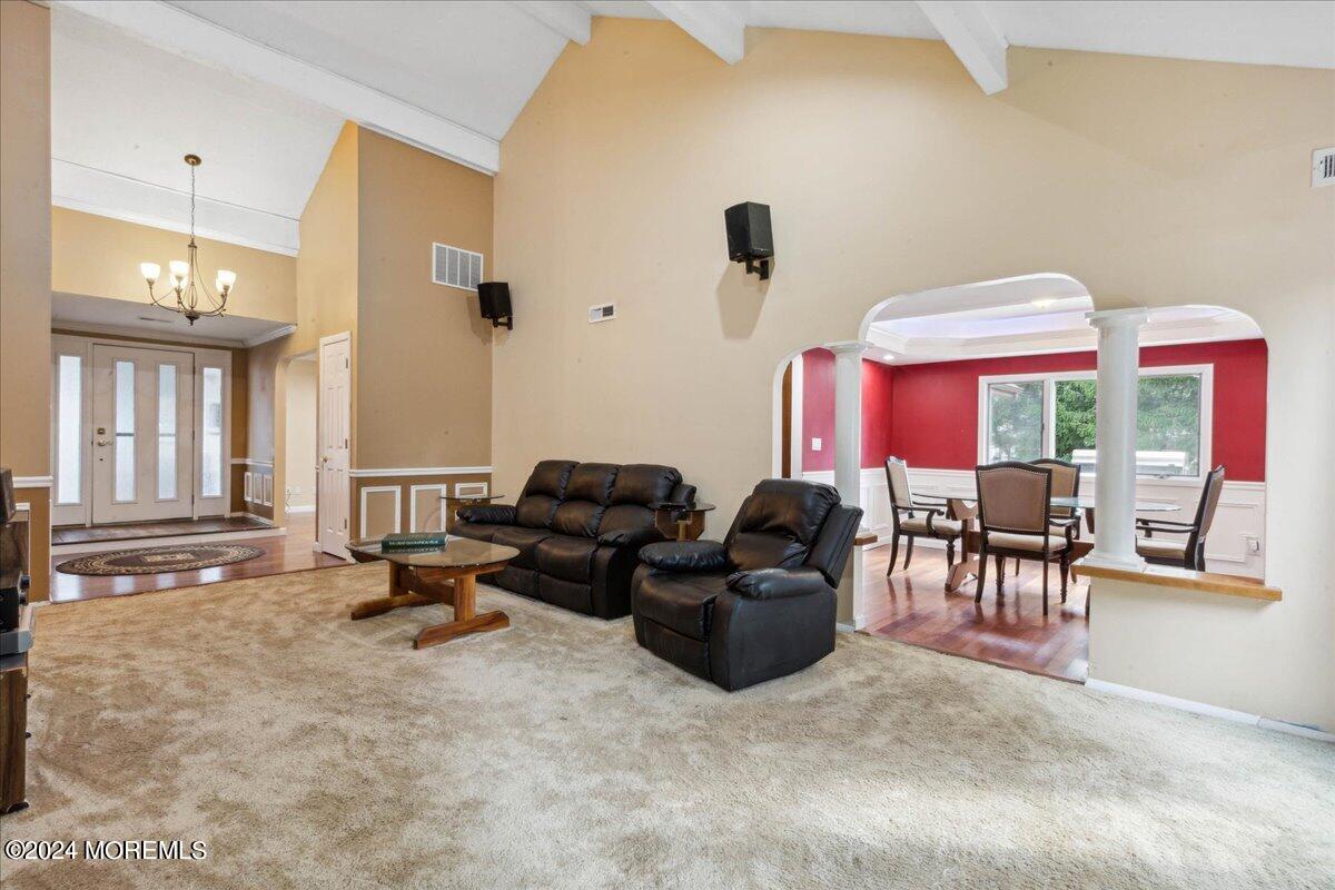 490 Iron Bridge Road Freehold, NJ 07728 - Photo 16 of 40 a living room with furniture a window and a flat screen tv
