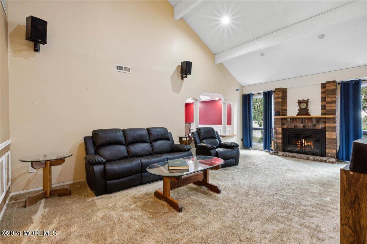 490 Iron Bridge Road Freehold, NJ 07728 - Photo 17 of 40 a living room with furniture and a fireplace