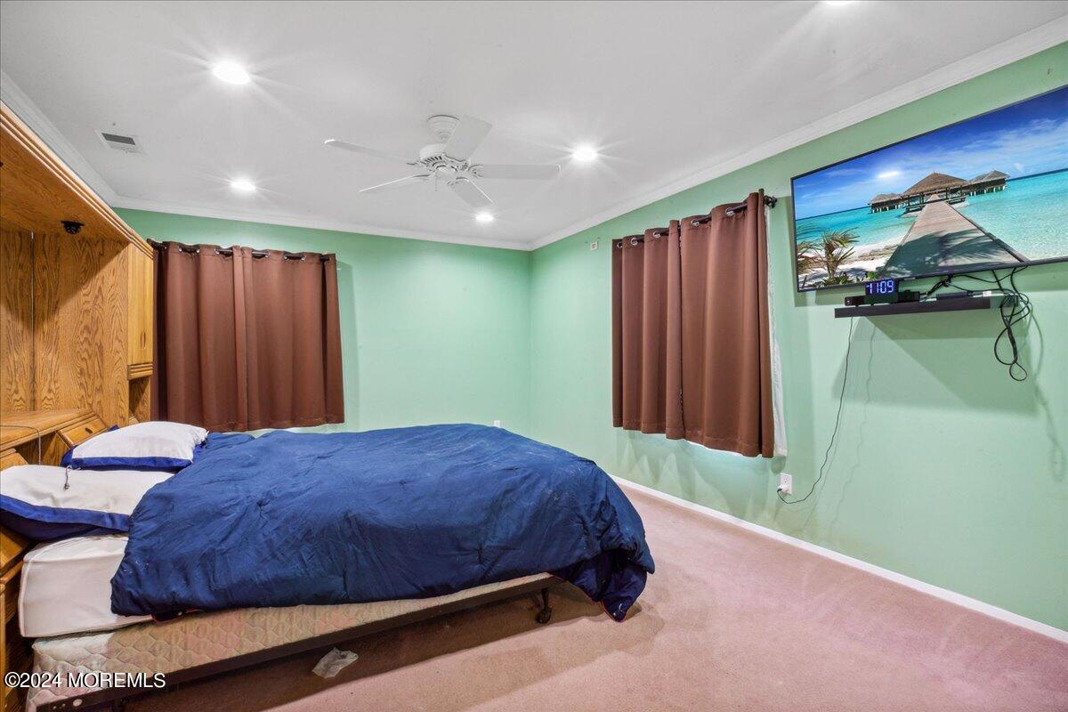 490 Iron Bridge Road Freehold, NJ 07728 - Photo 18 of 40 a bedroom with a bed and a mirror