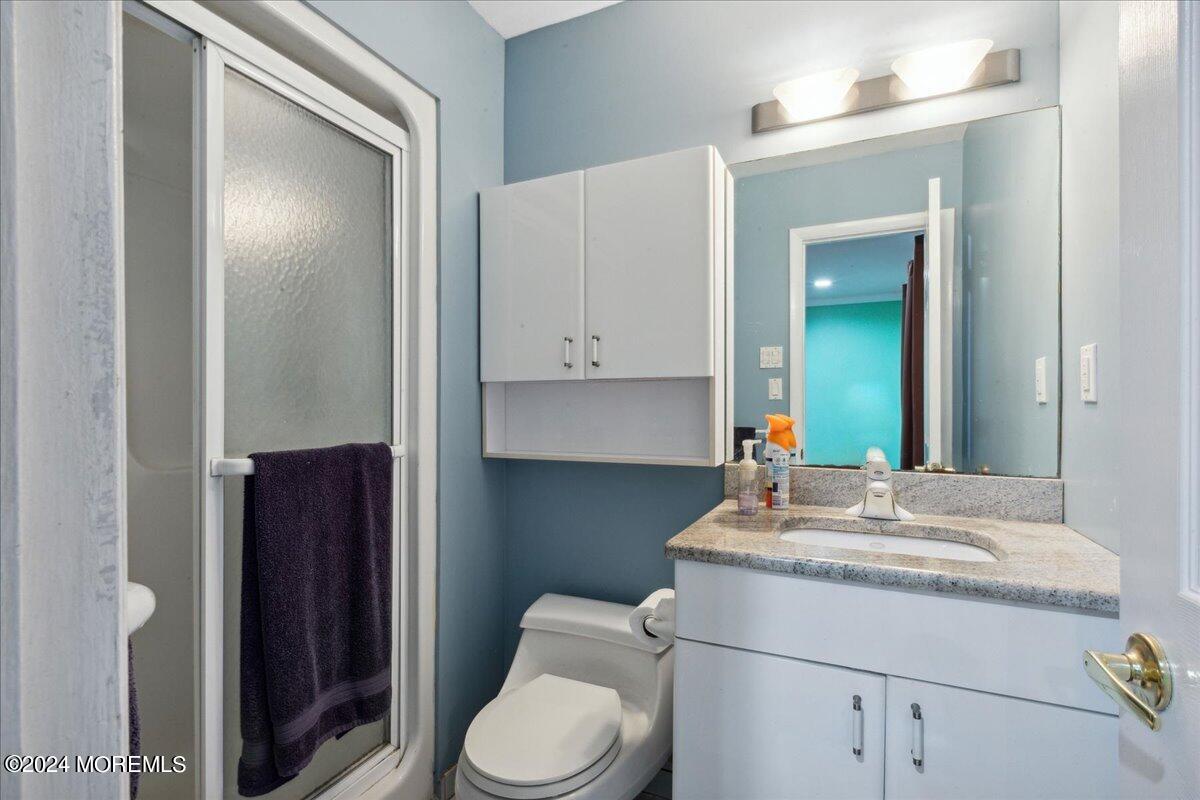 490 Iron Bridge Road Freehold, NJ 07728 - Photo 20 of 40 a bathroom with a sink a toilet and mirror