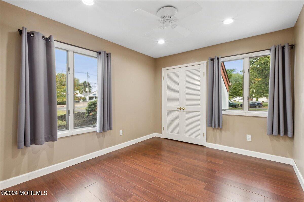 490 Iron Bridge Road Freehold, NJ 07728 - Photo 21 of 40 a view of an empty room with wooden floor and a window