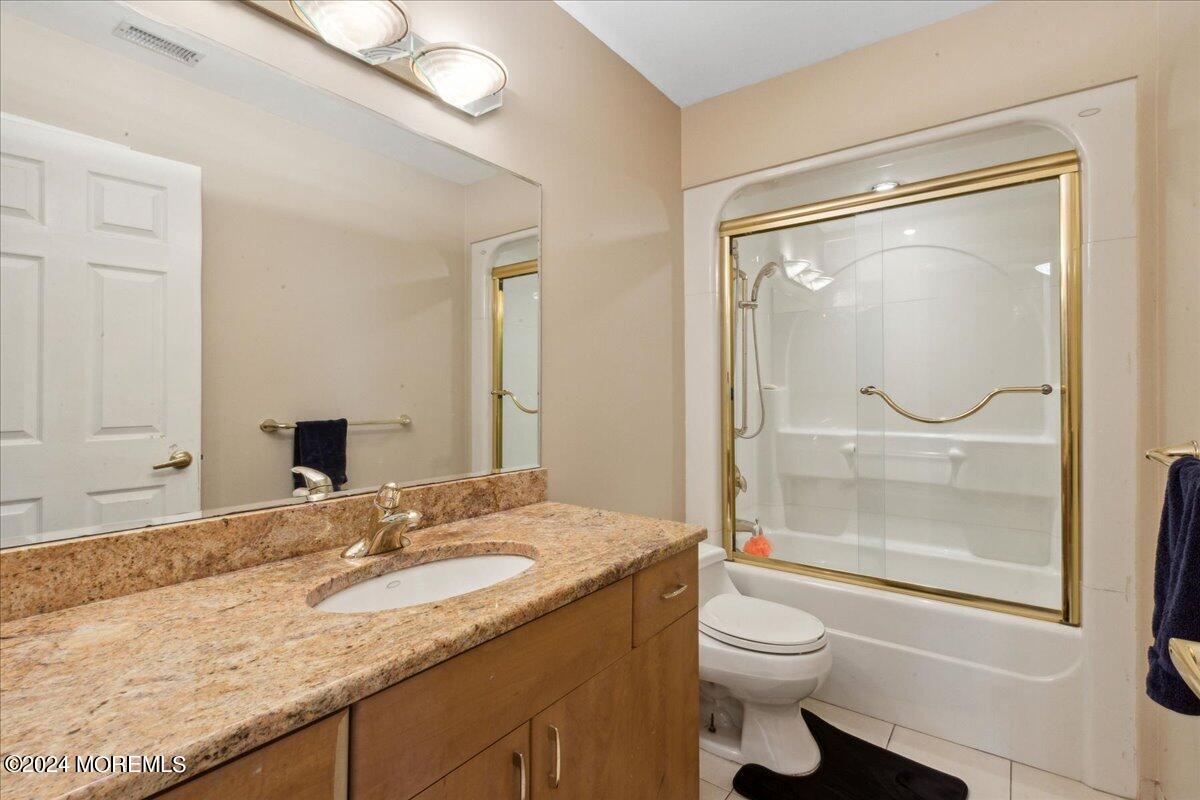 490 Iron Bridge Road Freehold, NJ 07728 - Photo 23 of 40 a bathroom with a granite countertop sink mirror vanity and toilet