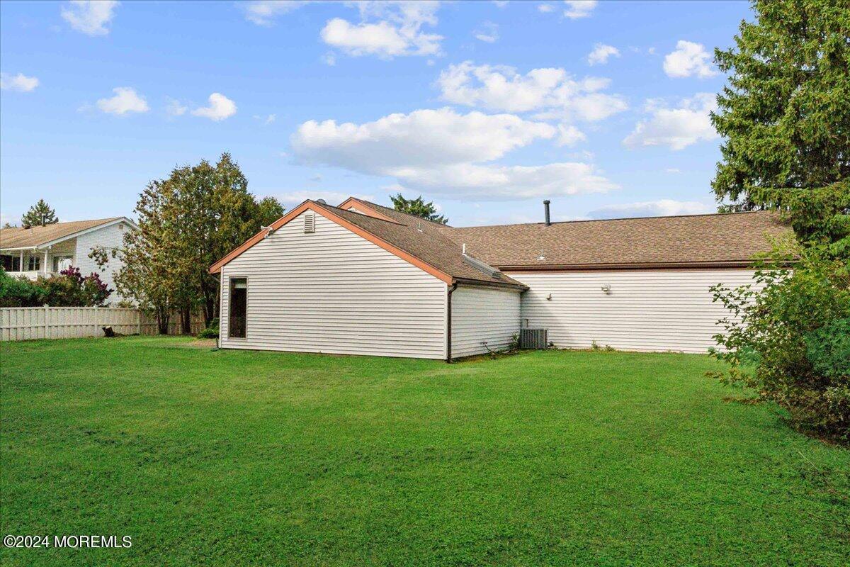 490 Iron Bridge Road Freehold, NJ 07728 - Photo 25 of 40 a view of a backyard with potted plants and large tree