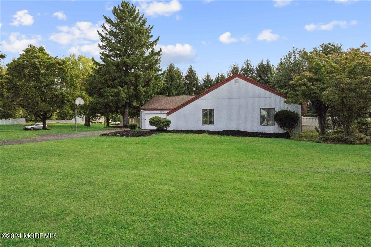490 Iron Bridge Road Freehold, NJ 07728 - Photo 3 of 40 a front view of a house with garden