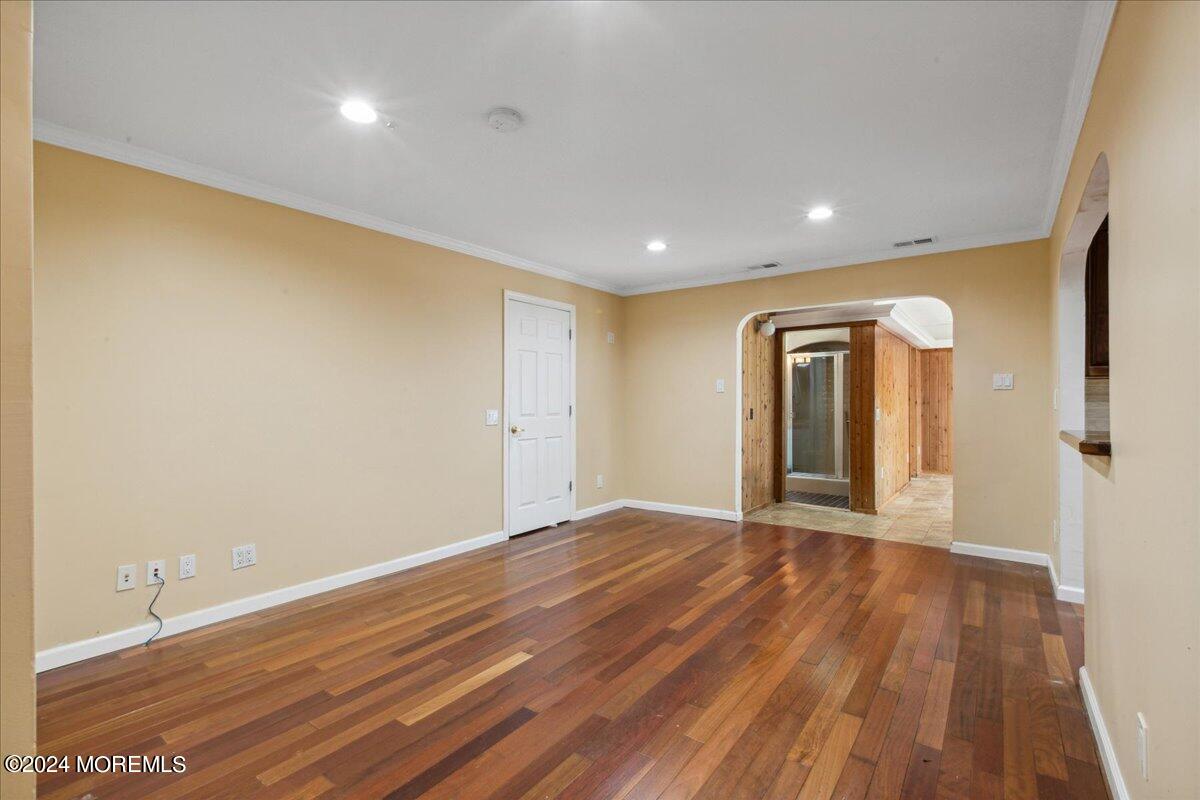 490 Iron Bridge Road Freehold, NJ 07728 - Photo 5 of 40 a view of an empty room with wooden floor and a window