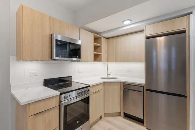 a kitchen with a sink and a refrigerator