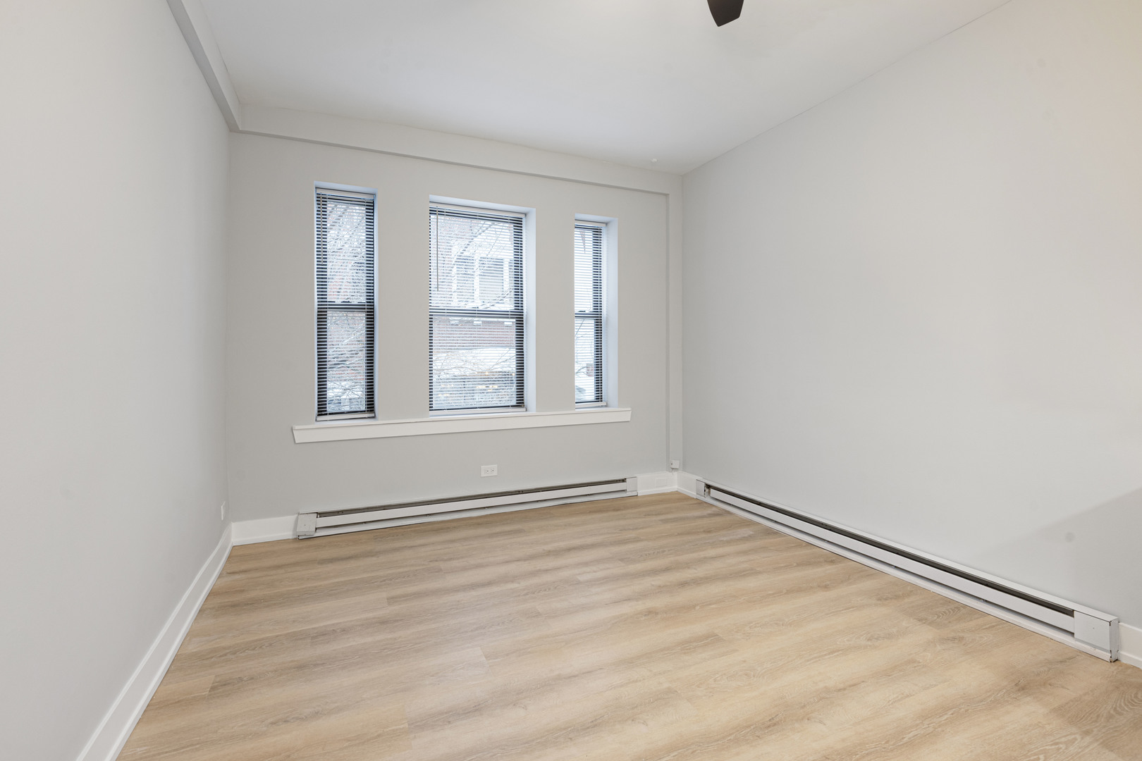 1634 West Howard Street, Unit 208 Chicago, IL 60626 - Photo 4 of 6 wooden floor in an empty room with a window