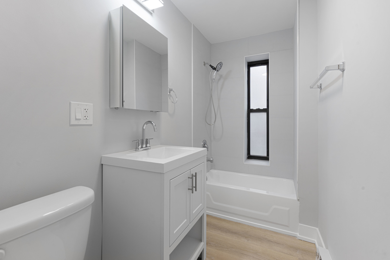 1634 West Howard Street, Unit 208 Chicago, IL 60626 - Photo 6 of 6 a bathroom with a sink a toilet and shower