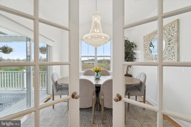 a dining room with furniture a chandelier and a rug